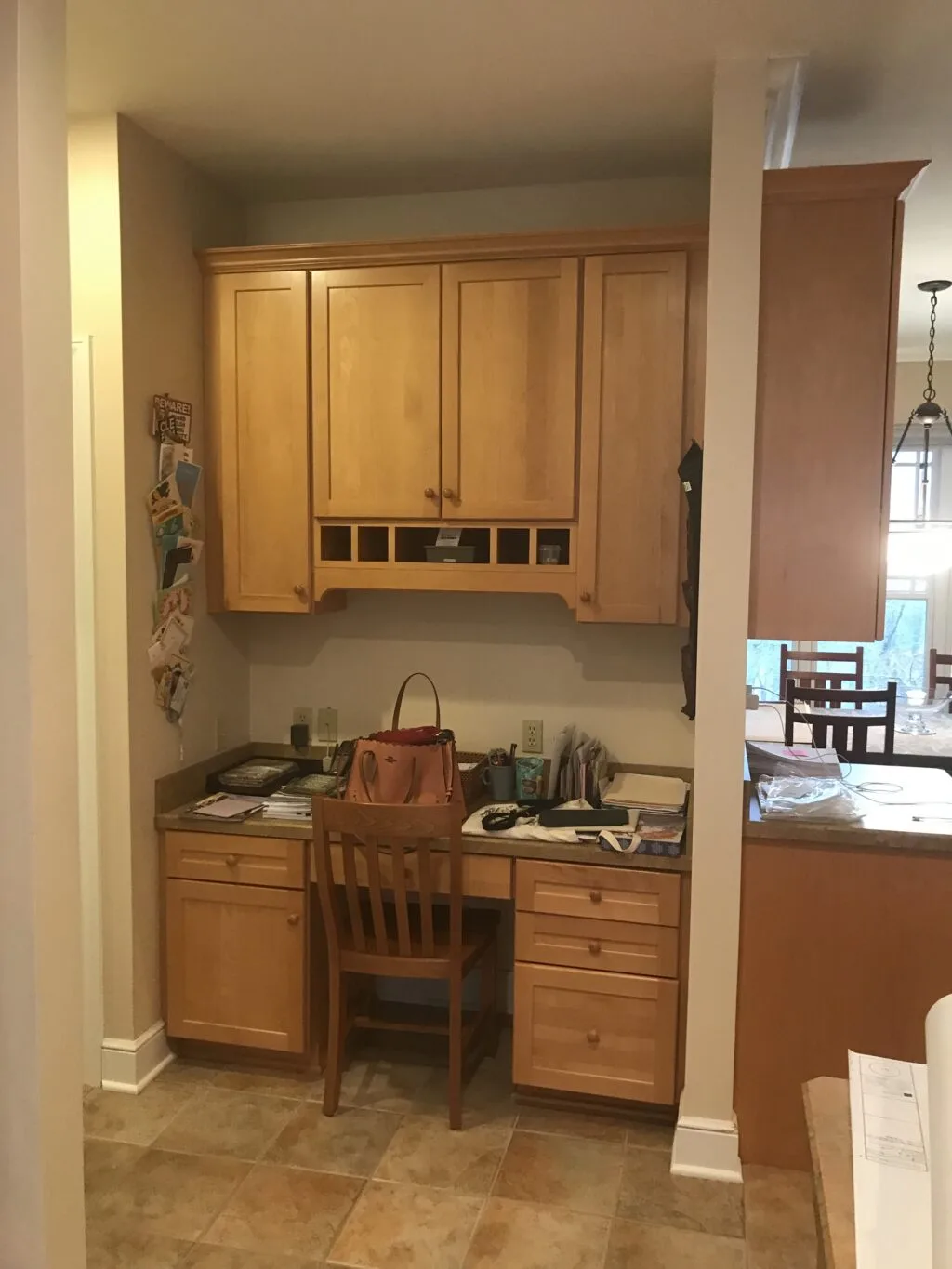 Desk nook in kitchen with oak cabinets
