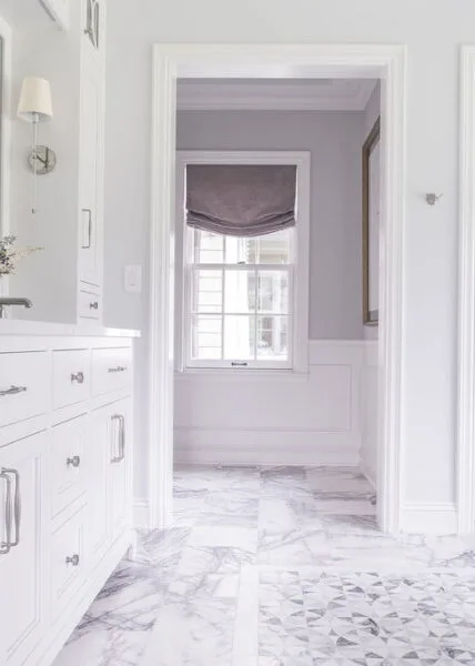 Moreland Hills home designed by Reflections Interior Design Bath room vanity and purple floor tile