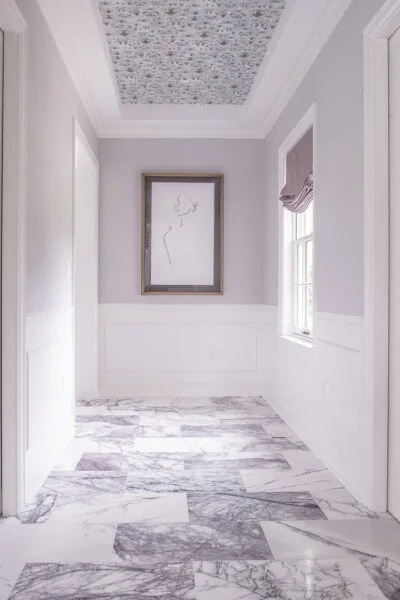 Moreland Hills home designed by Reflections Interior Design Entrance to bathroom with purple accents