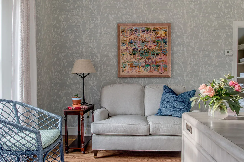 english roll arm sofa in an office space with bright artwork