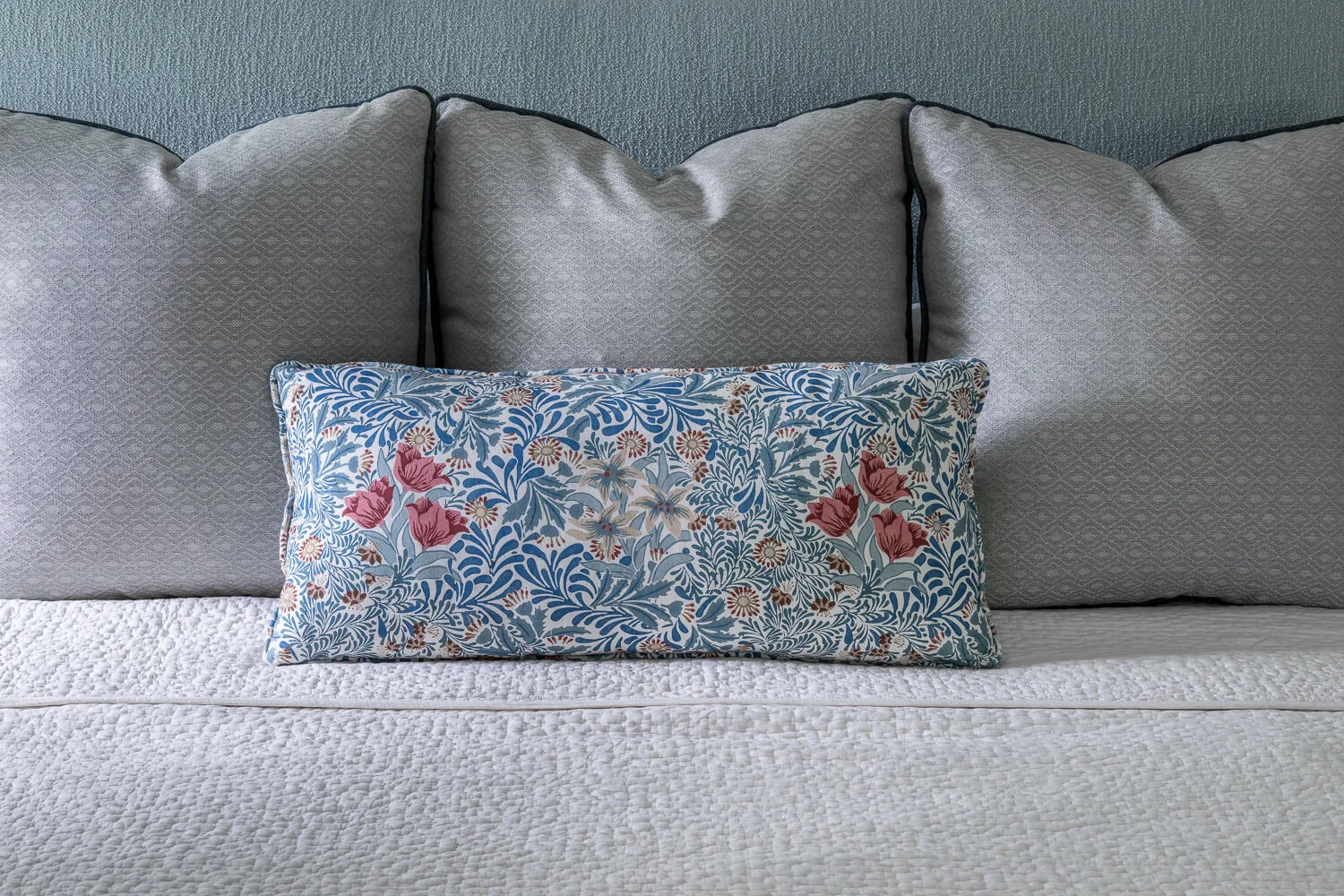 patterned pillows on the bed in the primary bedroom