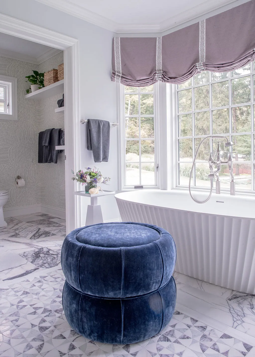 Soaking tub and blue ottoman