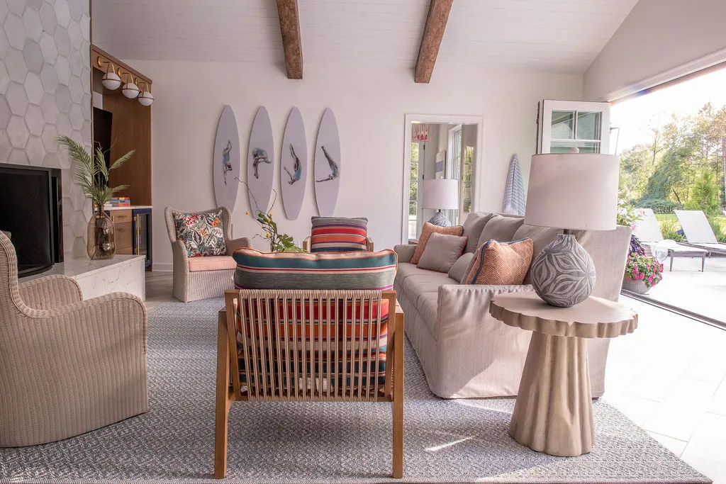 Eclectic poolhouse with surfboards on wall