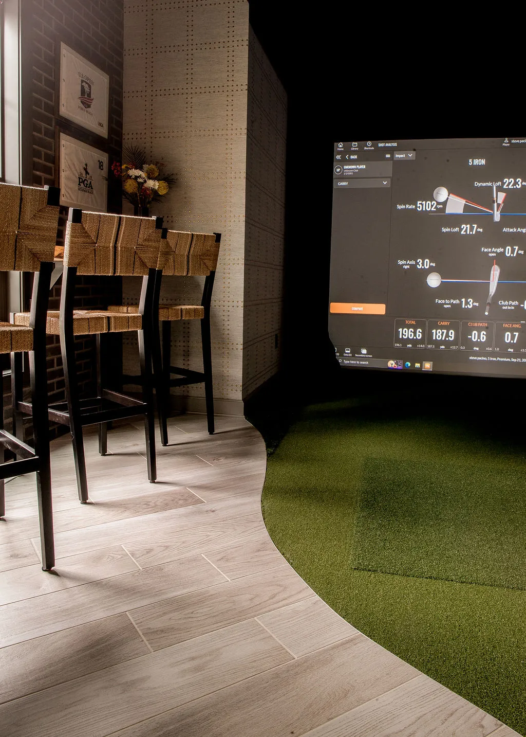 Golf simulator room with putting green
