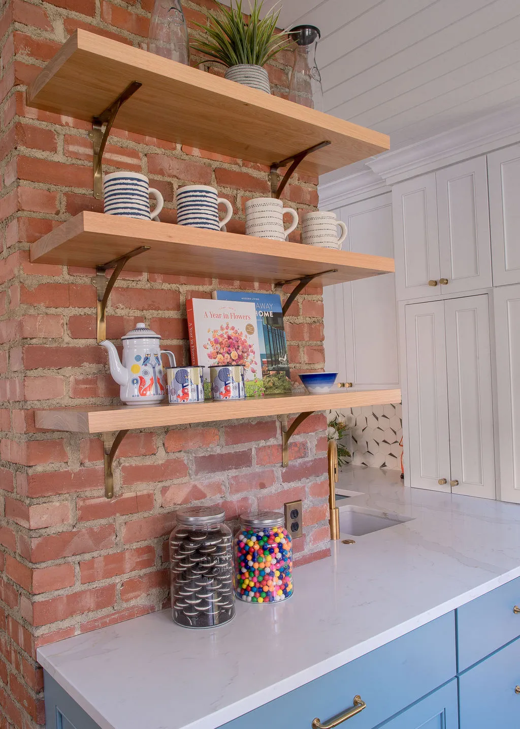 open shelving kitchen with exposed brick wall