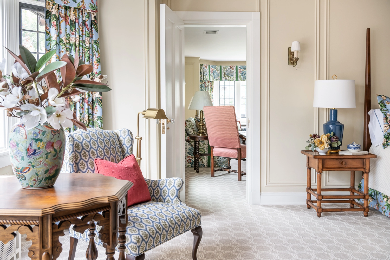 Focusing on an upholstered chair with the adjacent room in the background