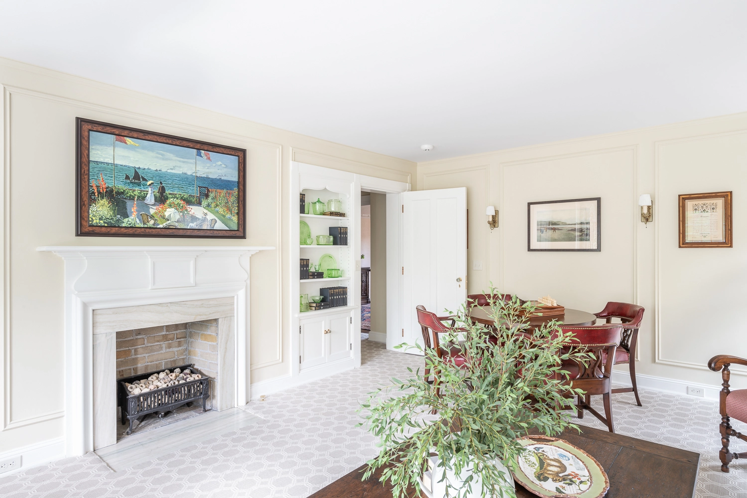 Image looking at a coffee table with florals and built-in shelves in the background