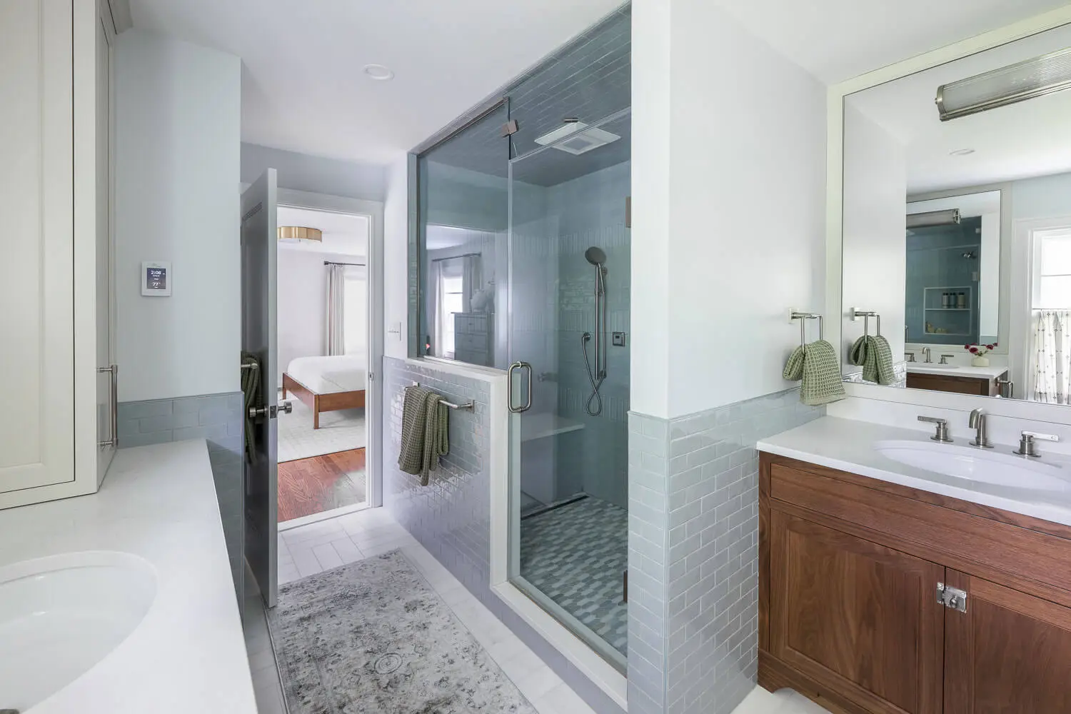remodelled bath shower with blue subway tile and marble floors
