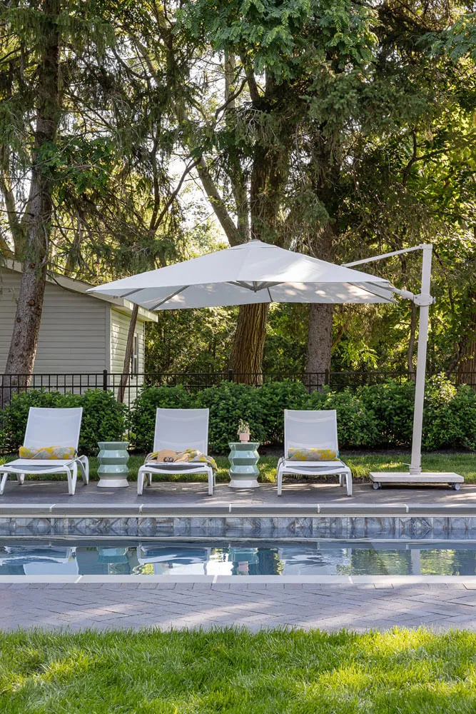 poolside lounge chairs with umbrellas