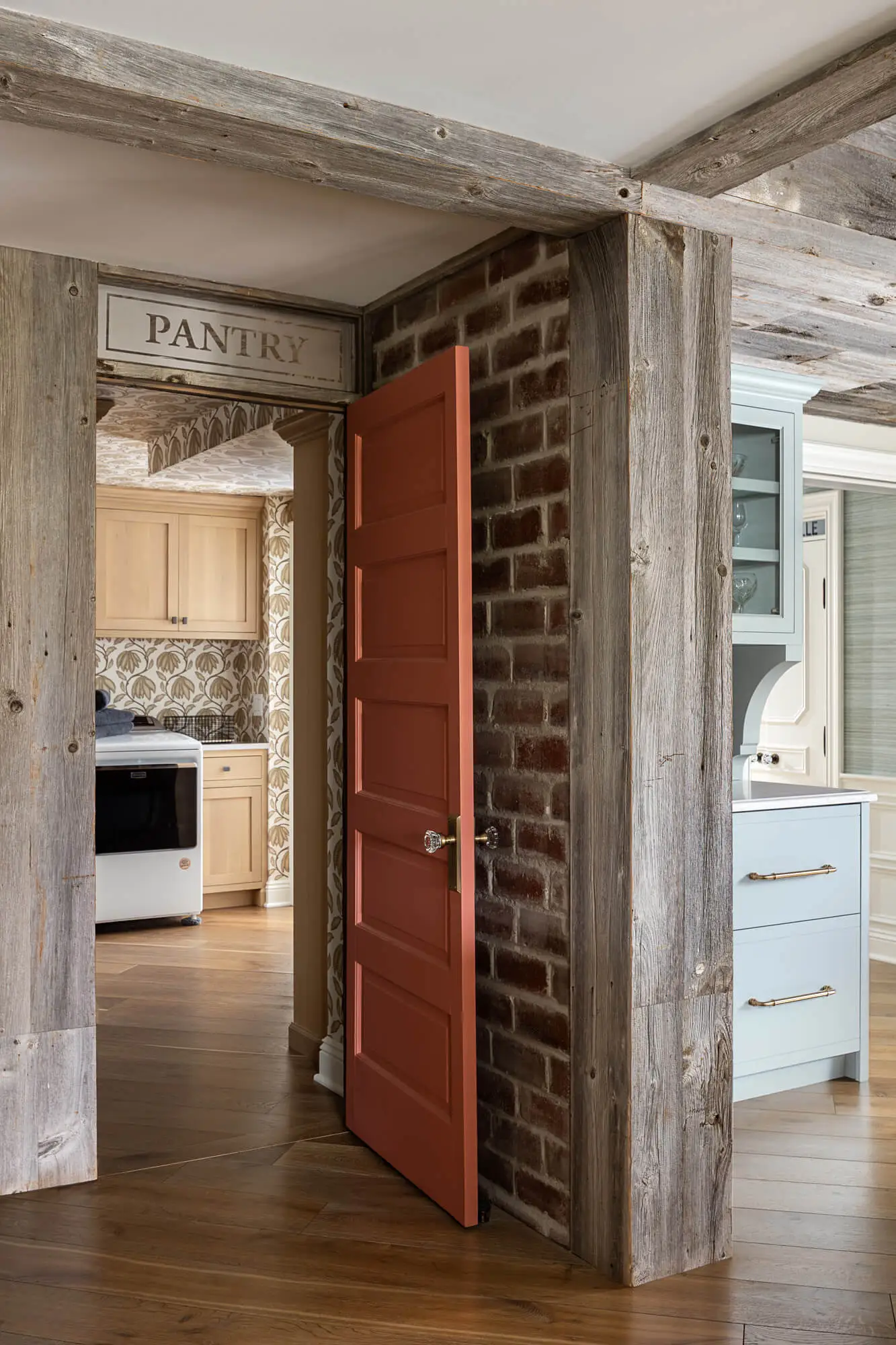 coral painted door that leads to pantry