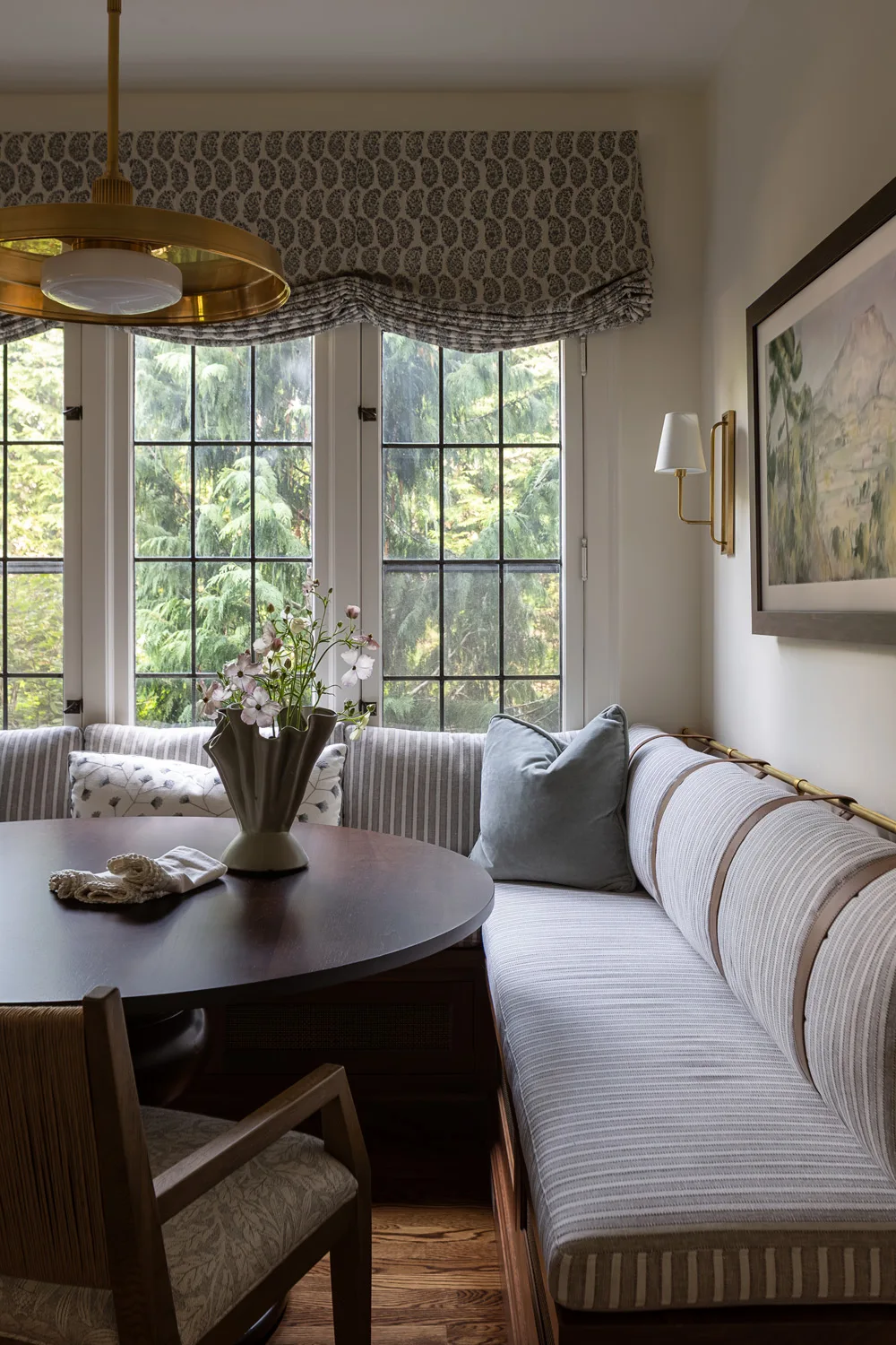 dining nook with roman shade and pendant light