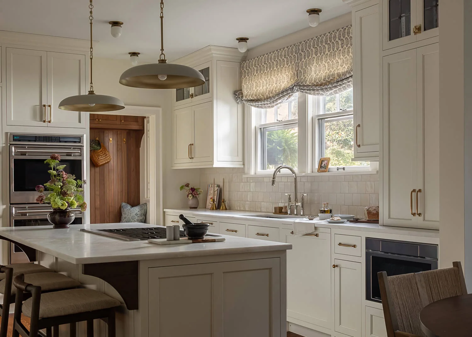 renovated kitchen space with large island and overhead lighting