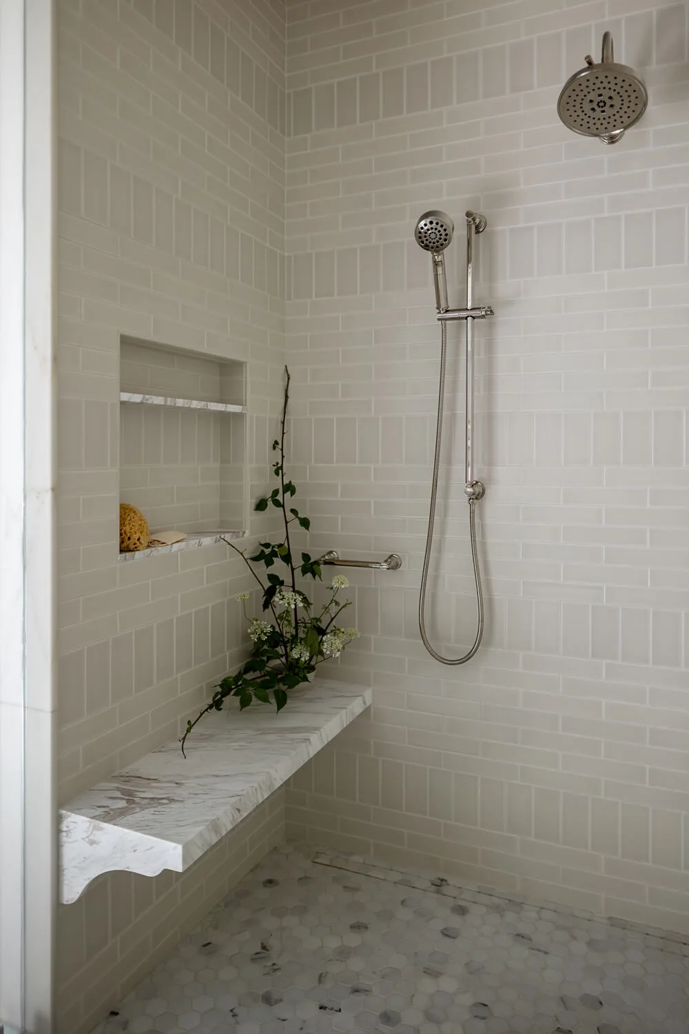 renovated shower with cream and white tiles