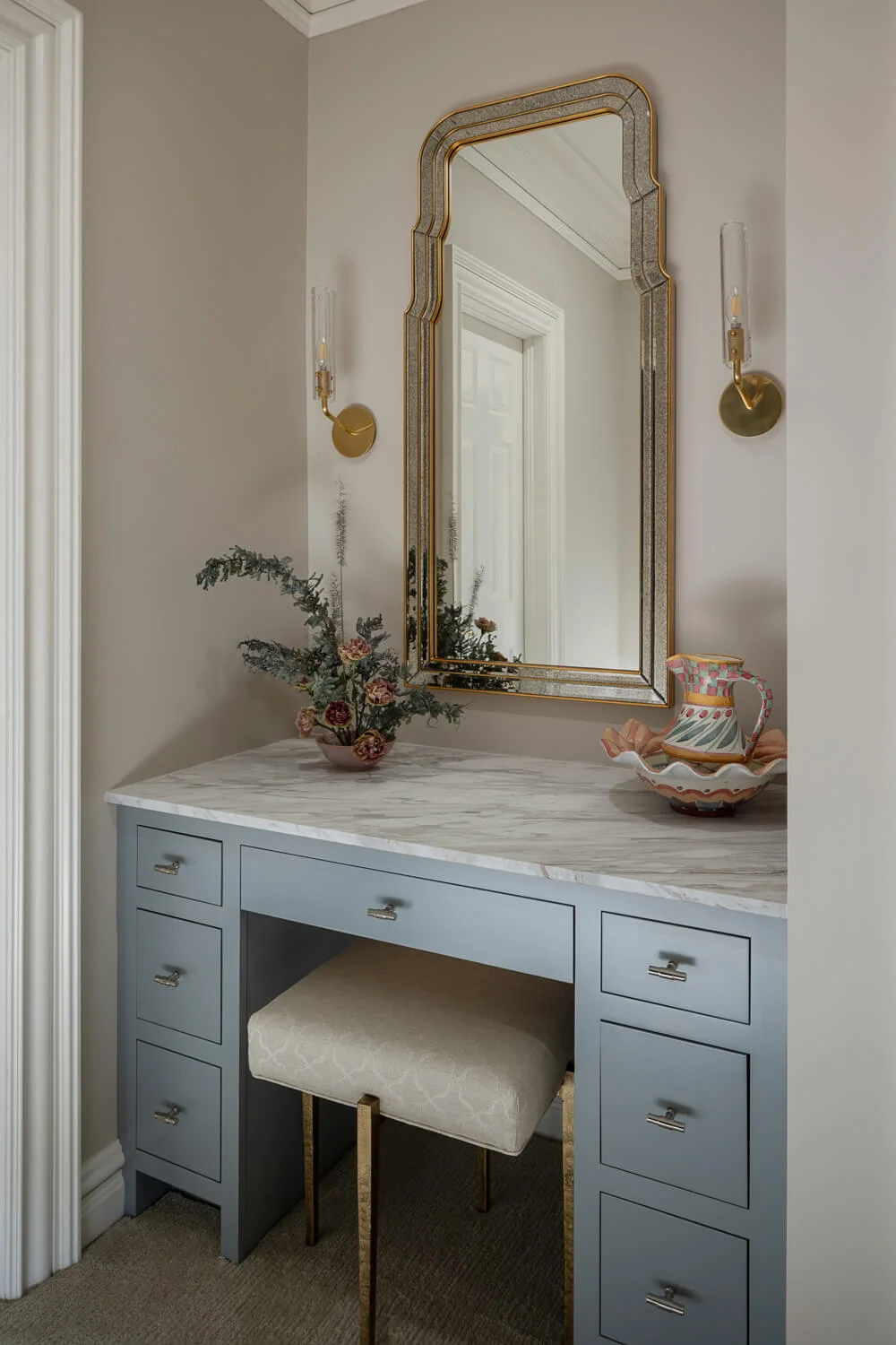 vanity in blue with gold mirror