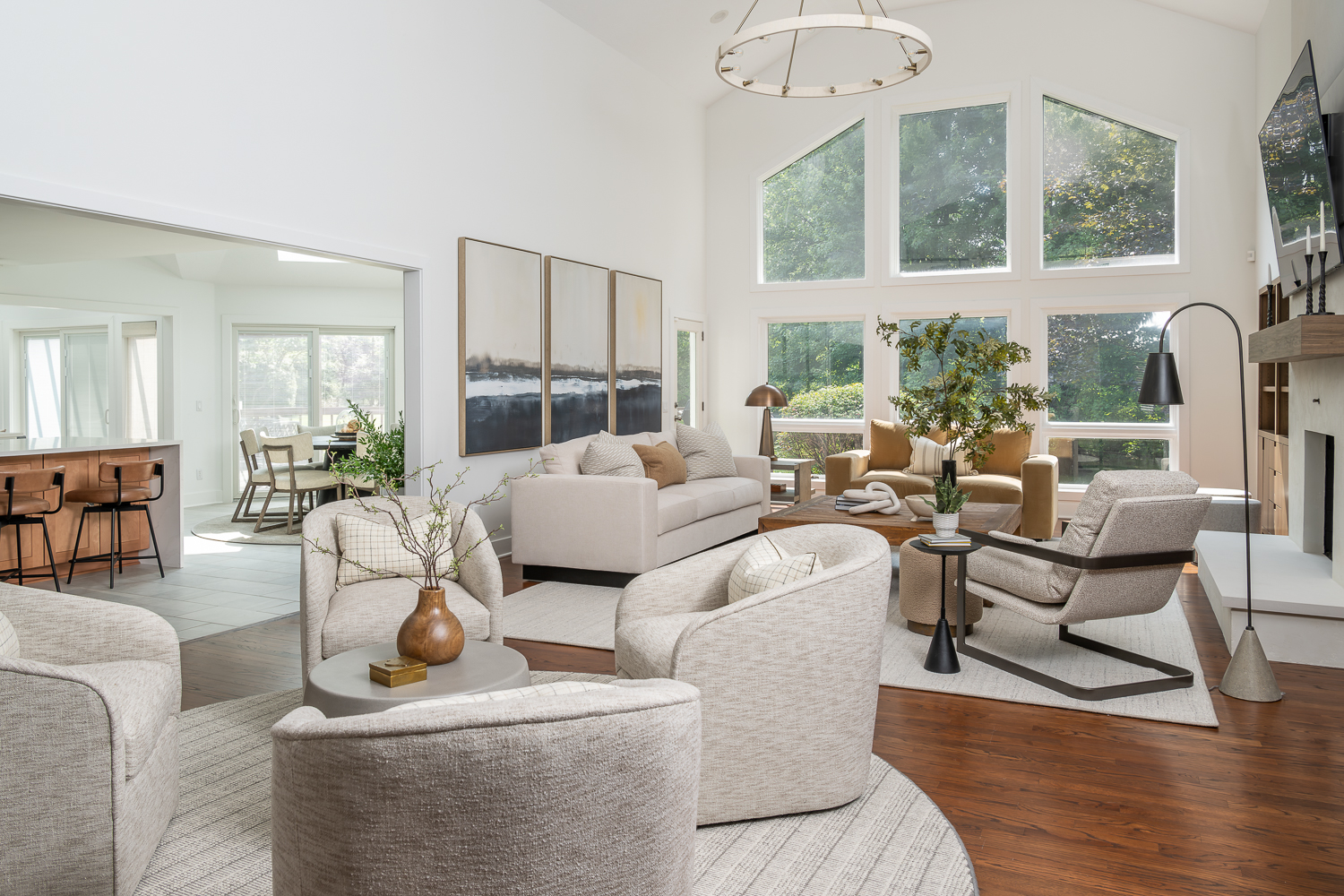 Great Room with modern plaster fireplace & neutral furniture